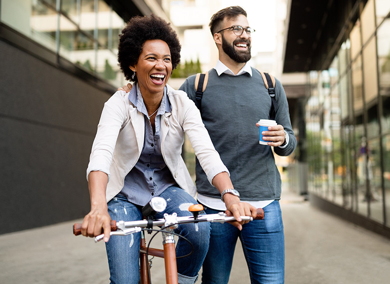 Man and woman happy while woman rides a bike