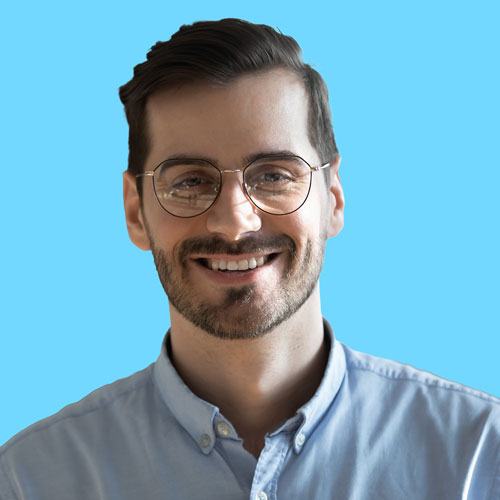 An image of a young, smiling man wearing glasses